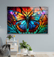a painting of a colorful butterfly on a blue wall