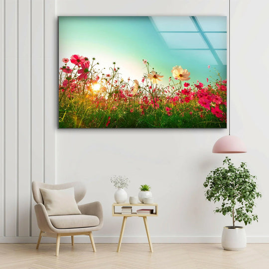 Vibrant pink poppies and a bright sun burst richly saturate this glass printing of a flower field under an azure sky.