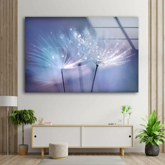 Capturing a serene mood, this glass wall art of a dandelion seed with dew drops adds delicate beauty to home decor.
