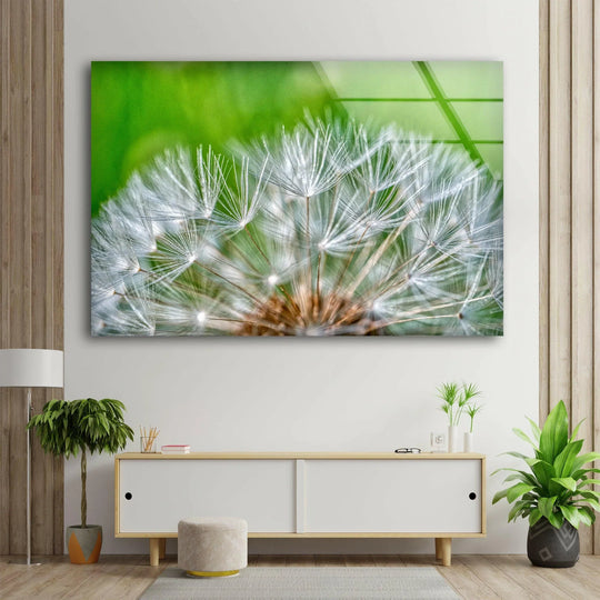 This white dandelion seed hanging wall art showcases a delicate layering effect of its ethereal seeds against a vibrant green backdrop.