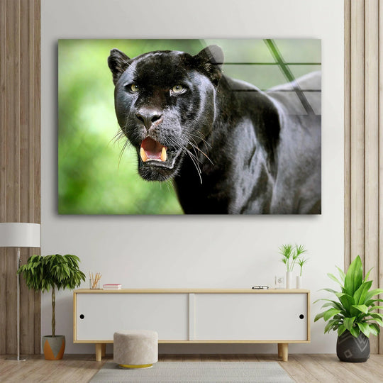Close-up of a majestic black panther with mouth open, displayed on striking glass wall art decor.