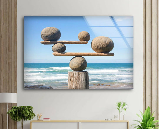 Abstract glass wall artwork captures serene stone balance against vibrant ocean hues.