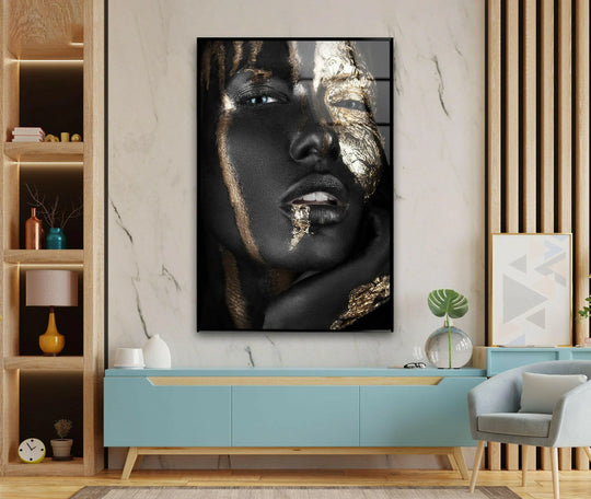 Intricate gold leaf textures create a striking layered effect against the dark, dramatic portrait within this glass wall artwork.