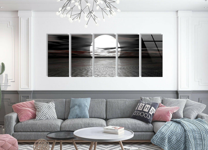 Dramatic black and white glass wall art featuring a large glowing moon rising over rippling water.