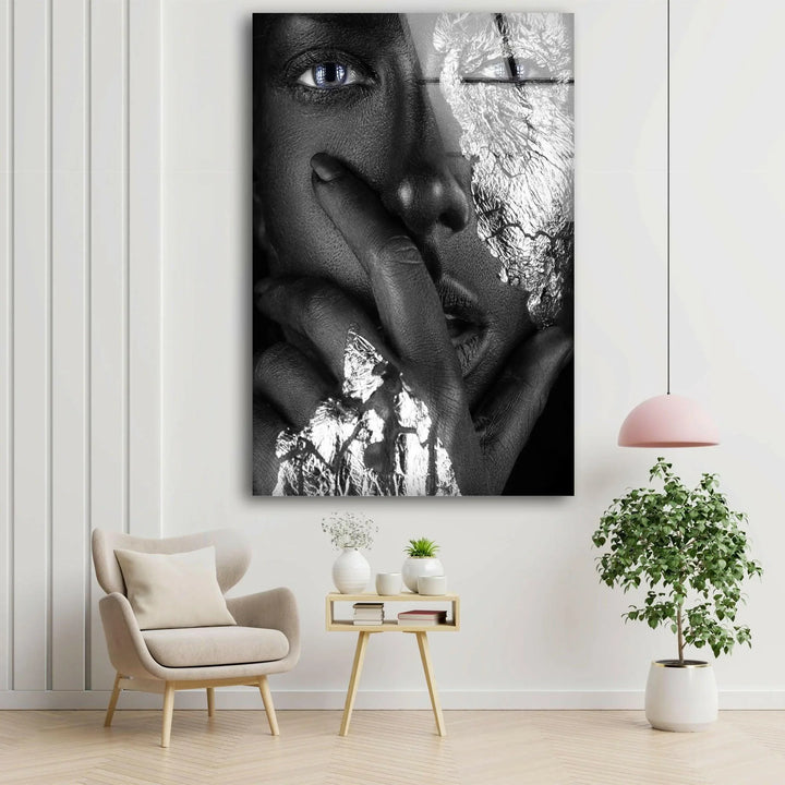 Stylish metallic portrait in black and white with bold blue eye highlights on glass art.