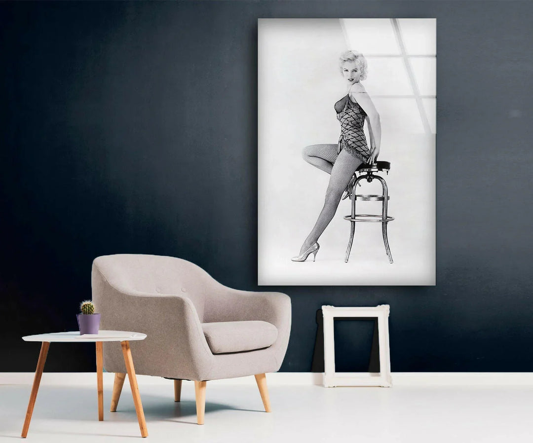 Black and white wall art showcasing Marilyn Monroe in a graceful seated fashion pose.