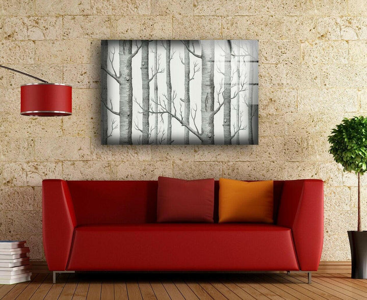 A serene black and white forest print featuring detailed birch trees on high-quality glass wall art.
