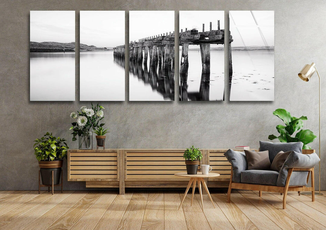 Black and white wall art capturing a tranquil lakeside scene with a decaying wooden pier.