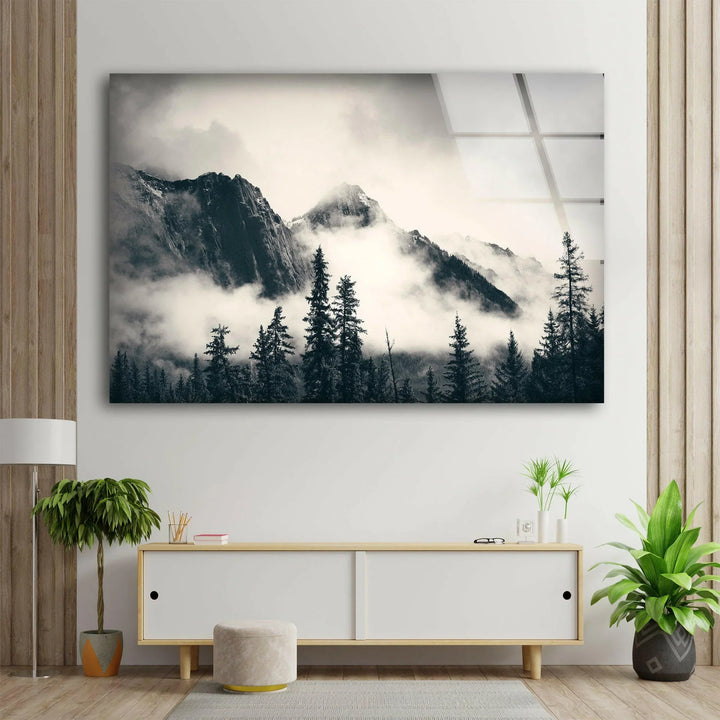 Calm monochrome landscape with fog rolling over rugged mountains and trees on glass décor.