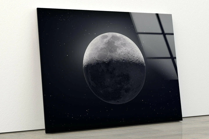 Lunar-themed glass art showing a half-shadowed moon in a deep night sky.