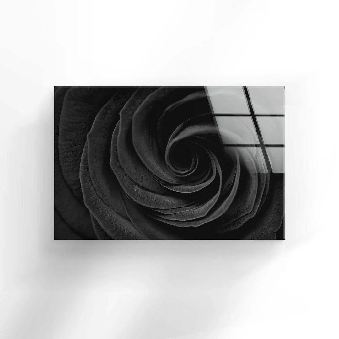 Textured black rose petals creating an elegant spiral composition on glass wall art.