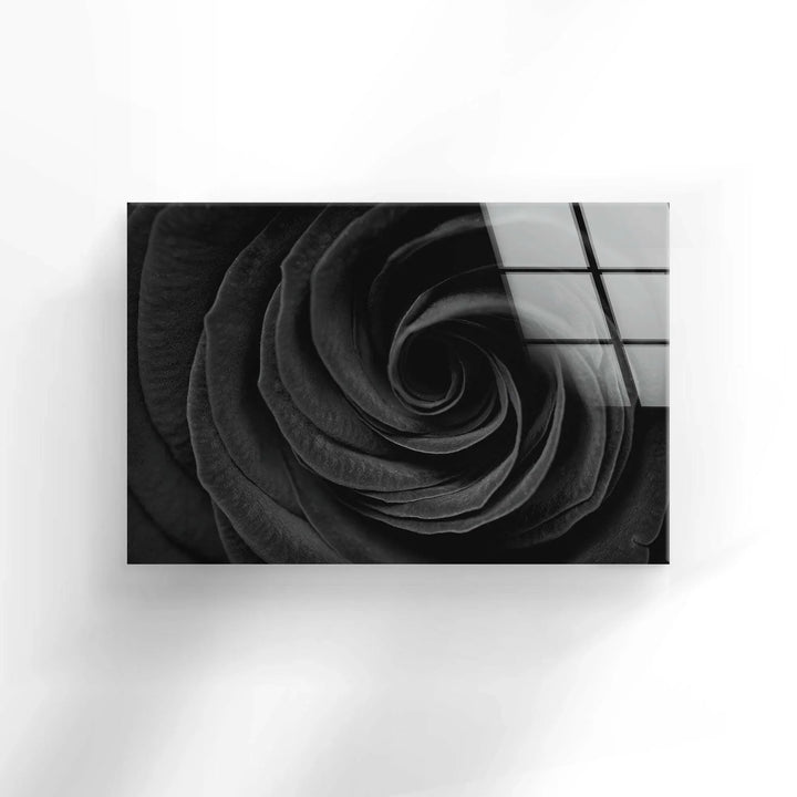 Textured black rose petals creating an elegant spiral composition on glass wall art.