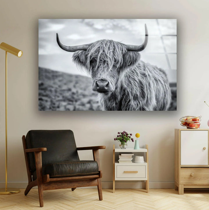 Black and white glass wall art featuring a Highland cow with long shaggy fur and wide horns.