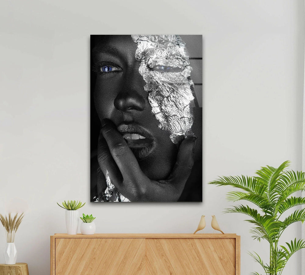 Modern black and white wall art showing a close-up metallic face accented with blue eyes.