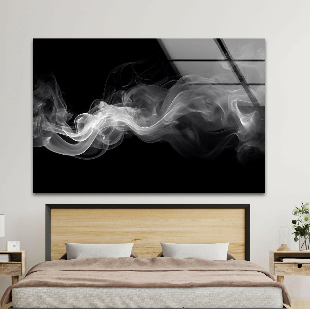 Grayscale abstract composition on glass portraying soft swirling smoke lines.