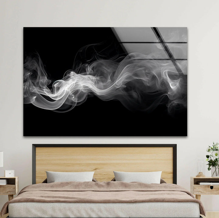 Grayscale abstract composition on glass portraying soft swirling smoke lines.