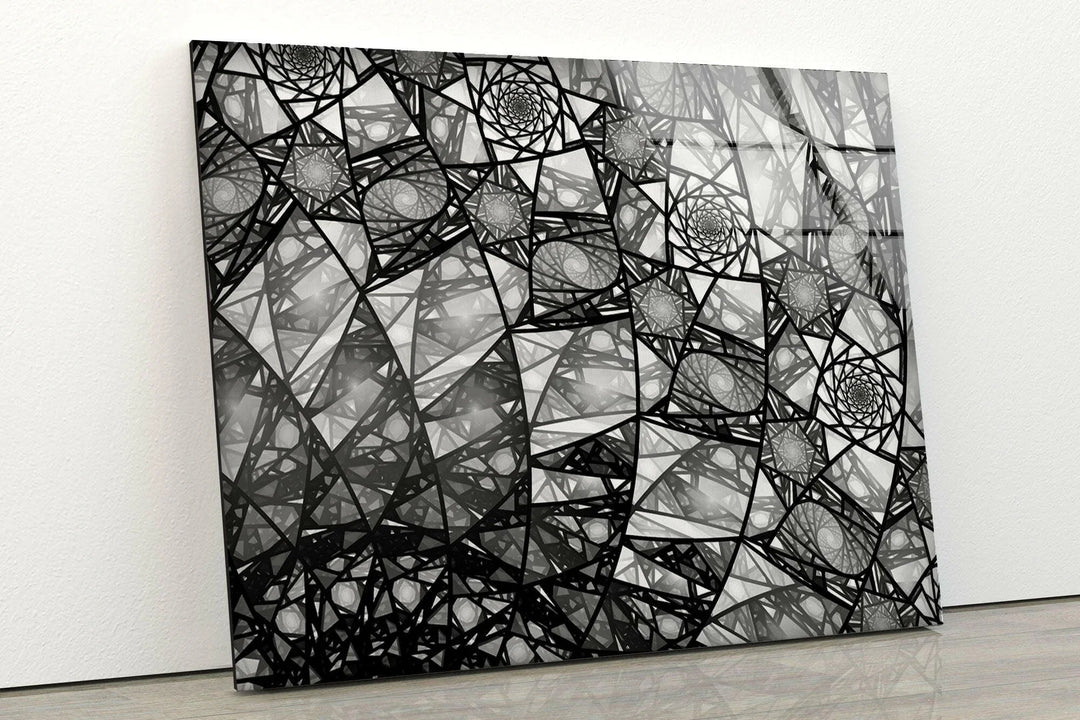 Abstract black and white fractal artwork featuring repeating spiral structures on glass.