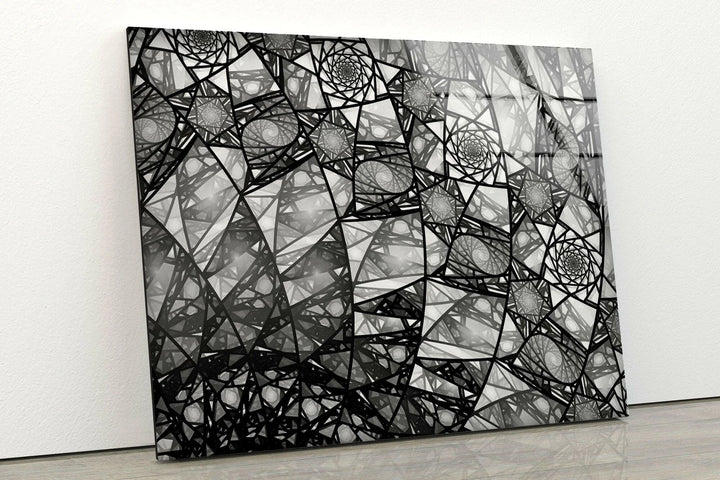 Abstract black and white fractal artwork featuring repeating spiral structures on glass.