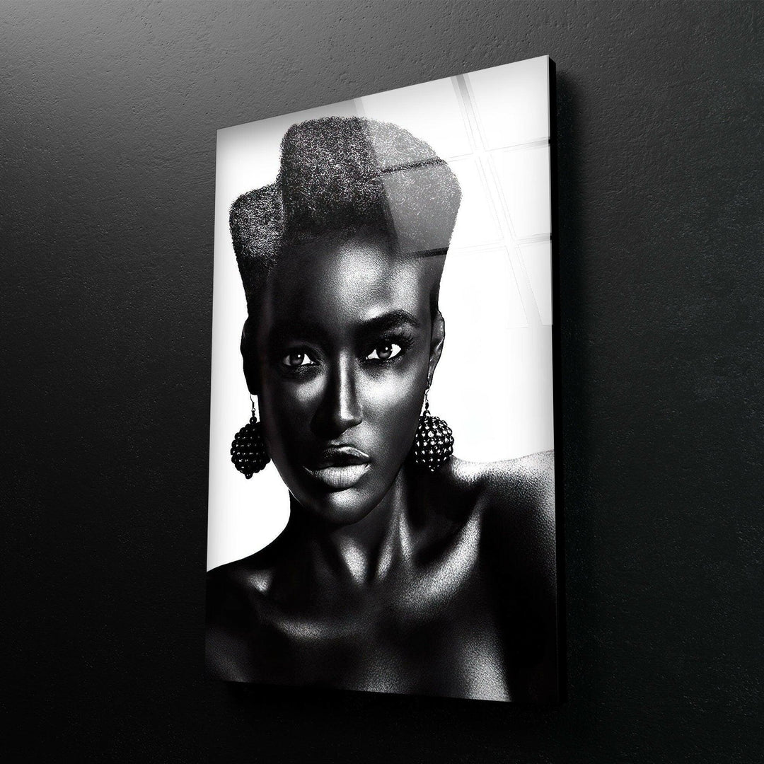 High-contrast black and white woman’s portrait with expressive eyes and textured earrings.