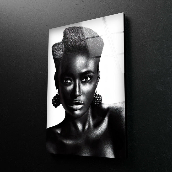 High-contrast black and white woman’s portrait with expressive eyes and textured earrings.